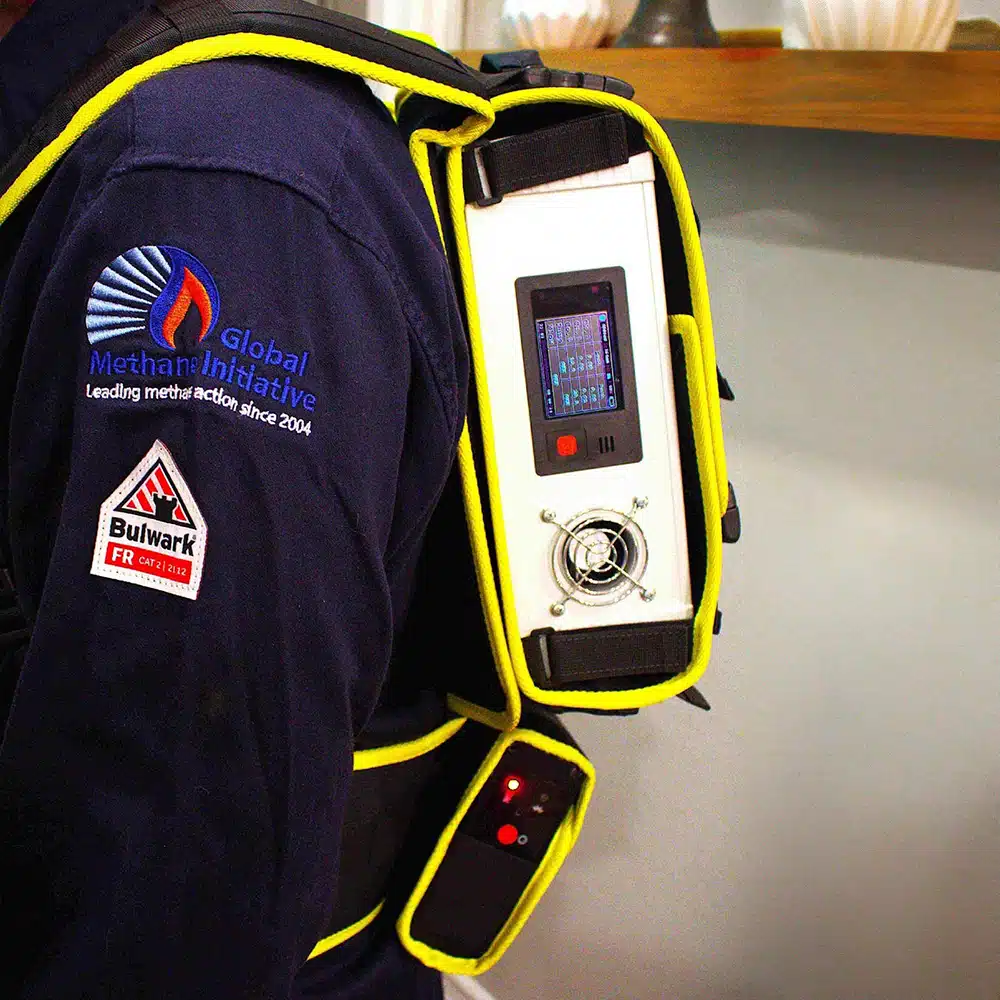 A man wearing the Addglobe Gas Flow Meter with Methane Laser Sensor Module Assembly